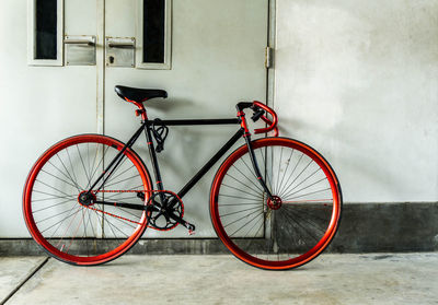 Bicycle parked against wall in building