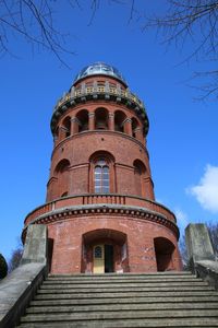 Low angle view of old building against blue sky