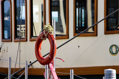 Life belt on railing by boat at harbor