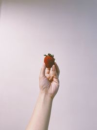 Close-up of hand holding strawberry