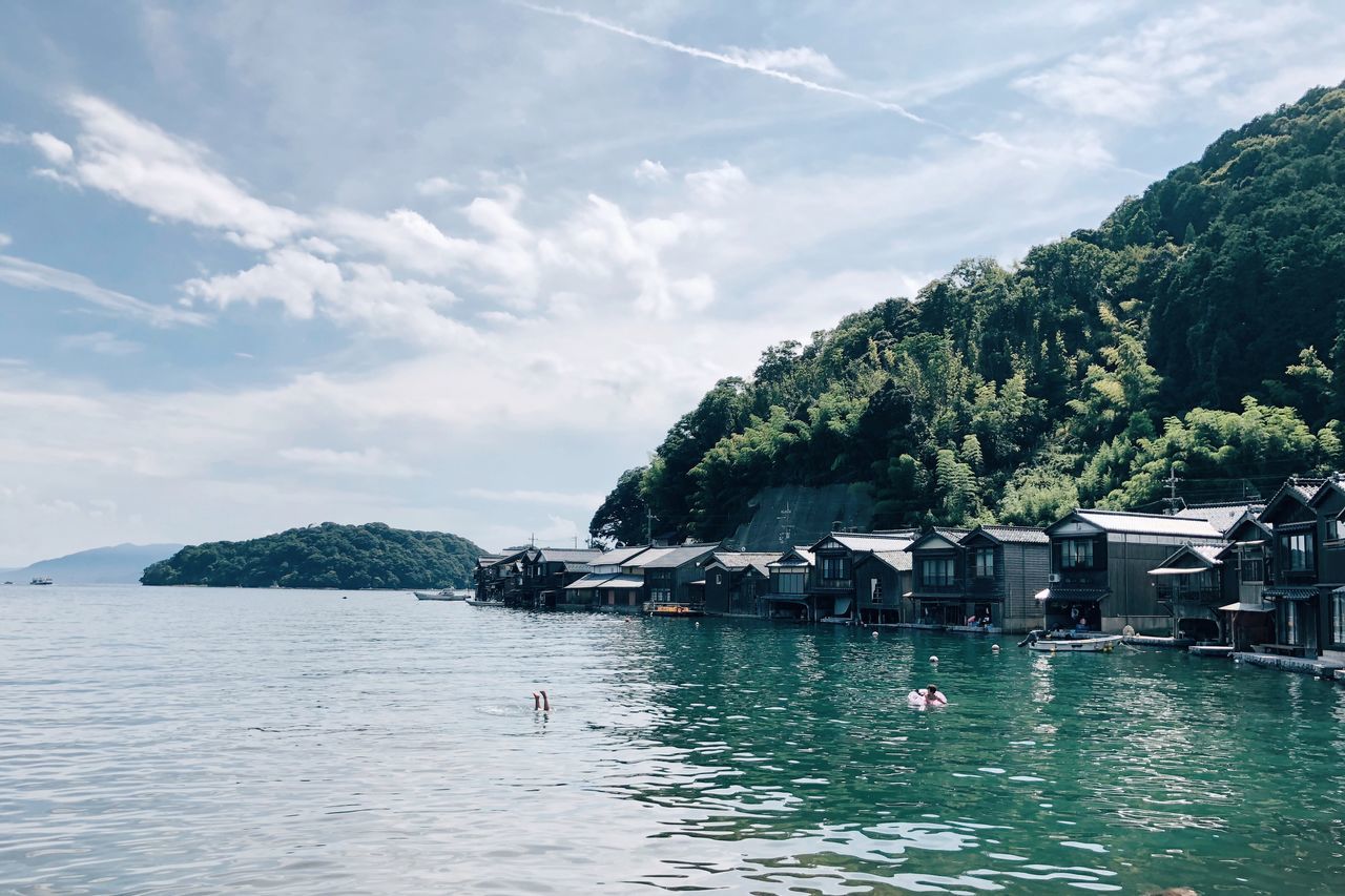 water, sea, waterfront, sky, tree, nature, beauty in nature, day, cloud - sky, plant, outdoors, scenics - nature, tranquil scene, tranquility, architecture, swimming, building exterior, built structure, people