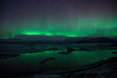 Scenic view of sea against sky at night during winter