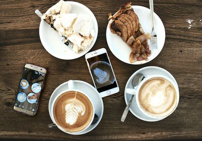 High angle view of breakfast and mobile phones on table