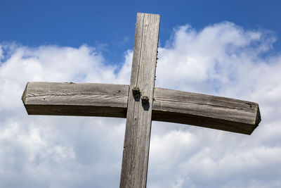 Low angle view of cross against sky