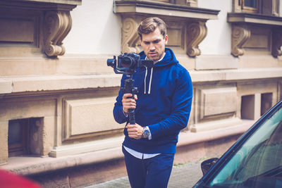 Full length of man standing against wall