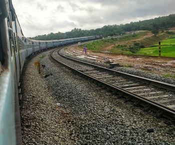 Train on railroad track against sky