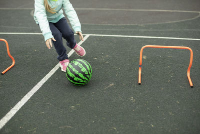 Low section of man playing soccer on field