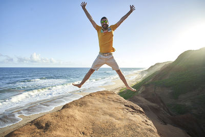 Full length of man on beach against sky