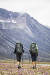 Rear view of two backpackers hiking in remote location, baffin island.