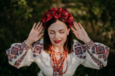 Woman with eyes closed wearing wreath