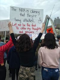 Rear view of people standing against the sky