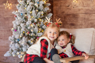 Portrait of happy girl with christmas tree