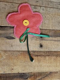 Close-up of flower shaped object on wood
