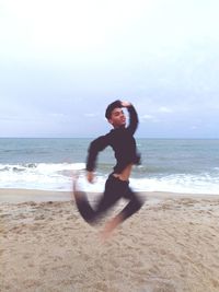 Full length of man on beach against sky