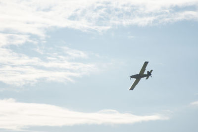 Low angle view of airplane flying in sky