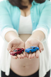 Close-up of woman holding toy cars