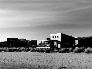 Houses on beach against sky