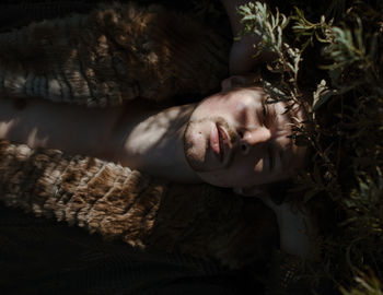 Directly above portrait of man lying on field