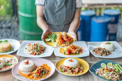 Midsection of man preparing food on table