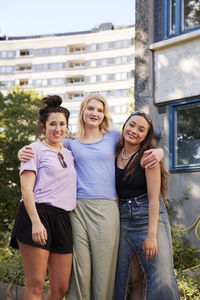 Portrait of young female friends spending time together outdoors