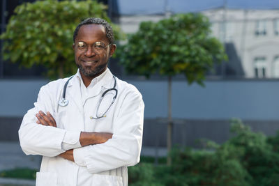 Portrait of male doctor standing in city