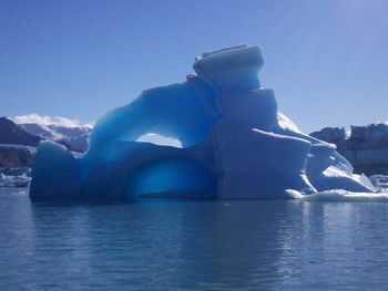 Ice floating on sea against sky