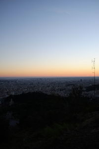 Scenic view of silhouette land against clear sky during sunset