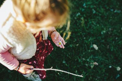 Close-up of girl holding a daisy