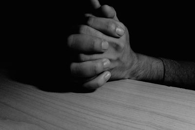 Cropped image of man with hands clasped 