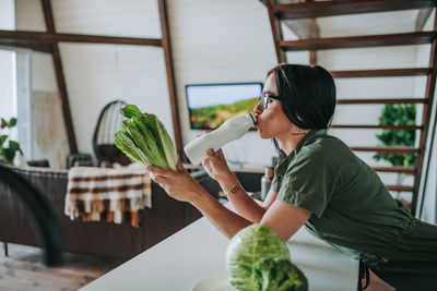 Woman holding food on table