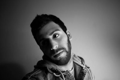 Portrait of young man against gray background