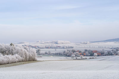 Scenic view of frozen landscape against sky