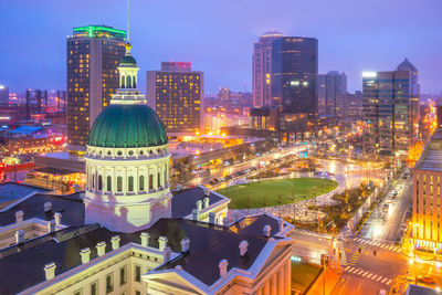 Aerial view of illuminated buildings in city at night