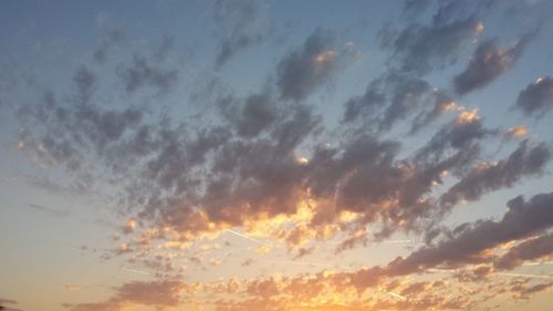 Low angle view of cloudy sky at sunset