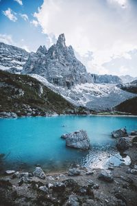 Scenic view of lake and mountains against sky