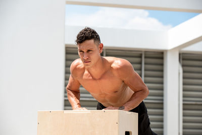 Shirtless man exercising outdoors