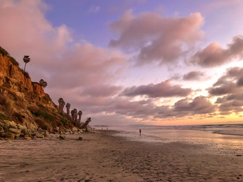 Scenic view of beach against sky during sunset