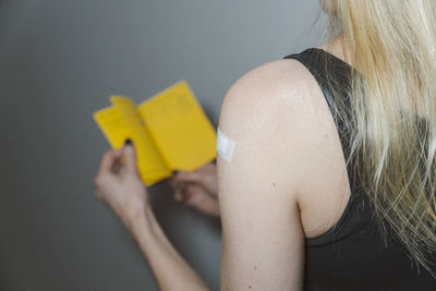 Blond woman with adhesive bandage on arm