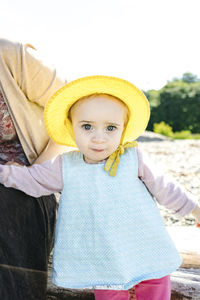 Closeup portrait of a young toddler girl in a sun hat on the beach  street fashion