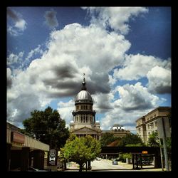 Buildings against cloudy sky