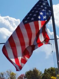 Low angle view of flag against sky