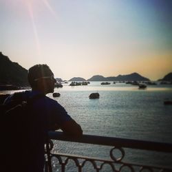 Man on river against sky