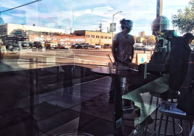 Rear view of city against sky