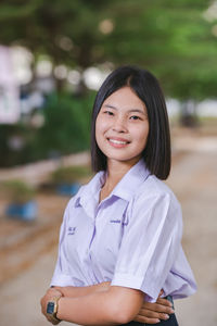 Portrait of young woman standing outdoors