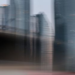 Blurred motion of buildings seen through glass window