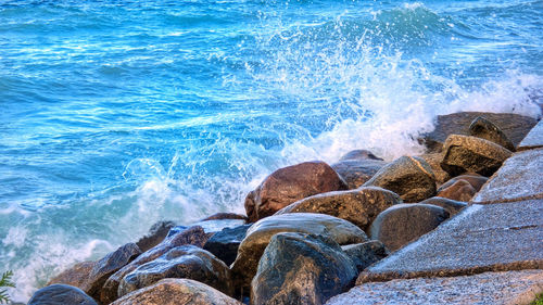 Waves splashing on rocks at shore