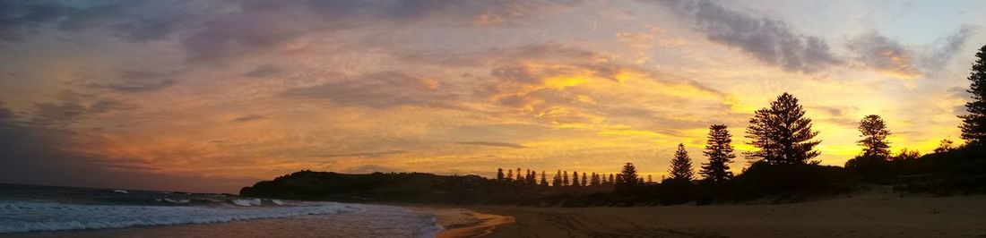 Panoramic view of beach against sky during sunset