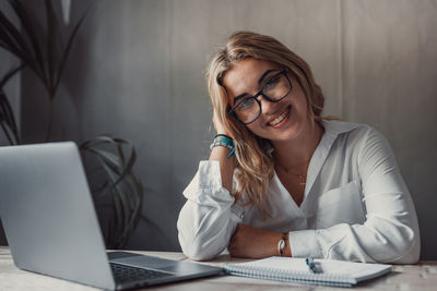 Young woman using laptop at table