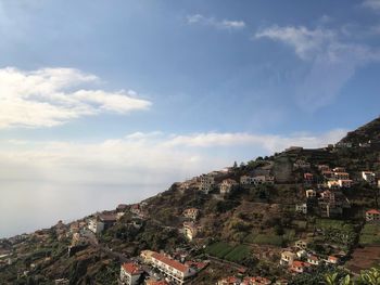 Townscape by sea against sky