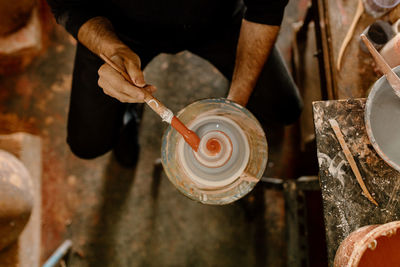 Midsection of man working in workshop